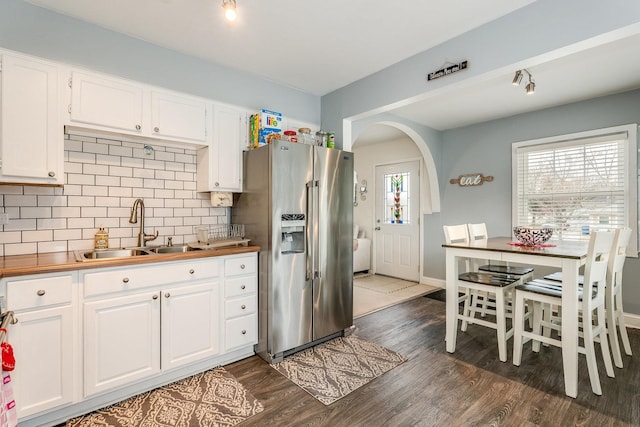 kitchen featuring tasteful backsplash, white cabinetry, sink, dark wood-type flooring, and high end fridge