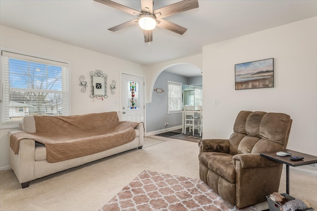 living room featuring ceiling fan and carpet