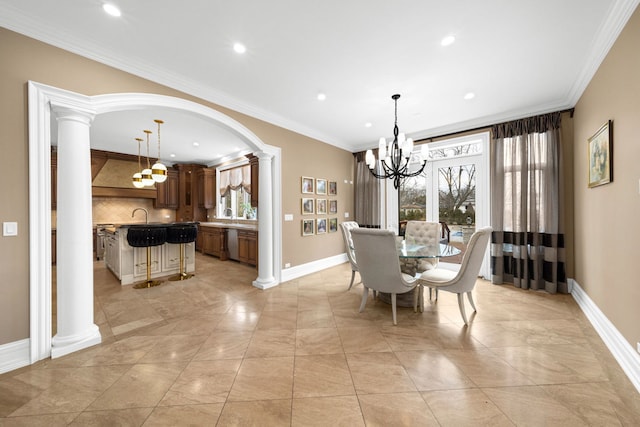 dining room with ornate columns, baseboards, crown molding, and an inviting chandelier