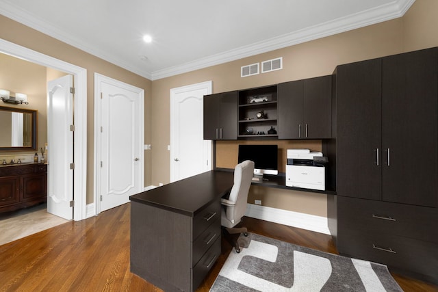 office featuring ornamental molding, visible vents, and wood finished floors