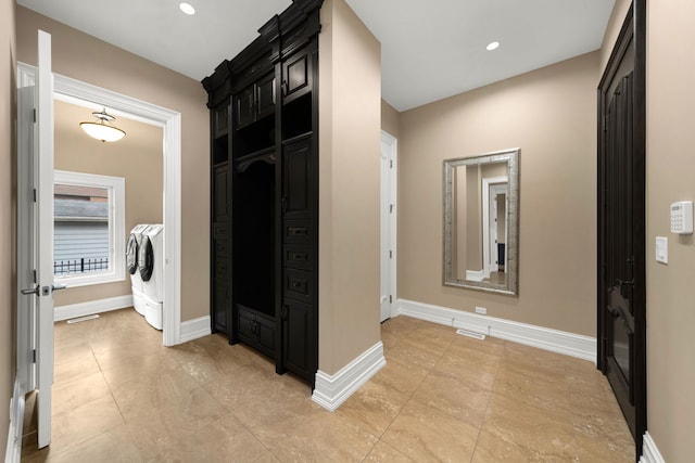 hall with baseboards, recessed lighting, visible vents, and washer and dryer