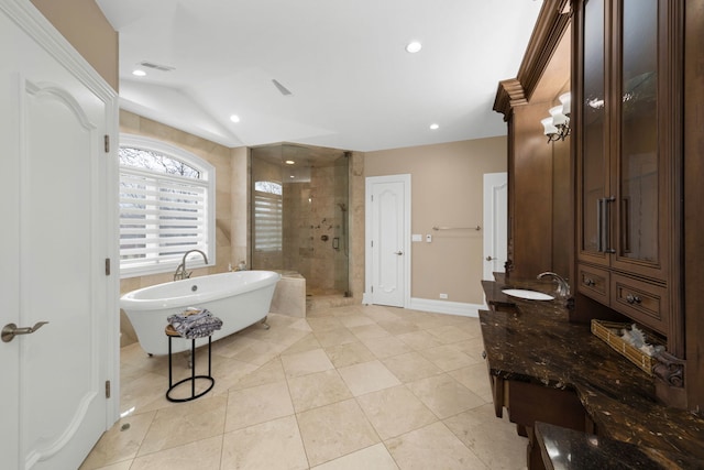 bathroom with lofted ceiling, vanity, visible vents, a freestanding bath, and a shower stall