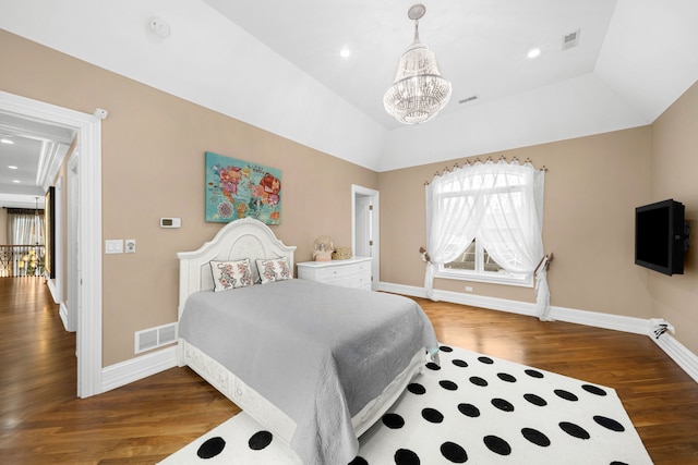 bedroom featuring lofted ceiling, baseboards, visible vents, and wood finished floors