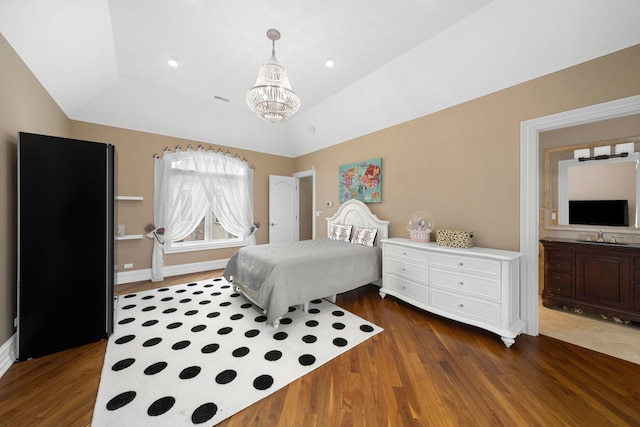 bedroom featuring lofted ceiling, recessed lighting, an inviting chandelier, and wood finished floors