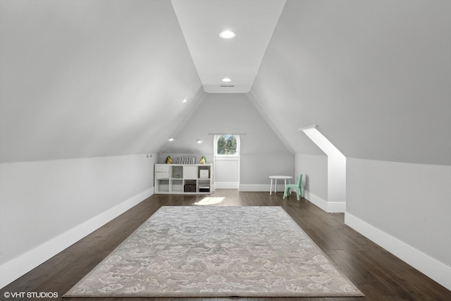 bonus room featuring baseboards, vaulted ceiling, and dark wood-type flooring