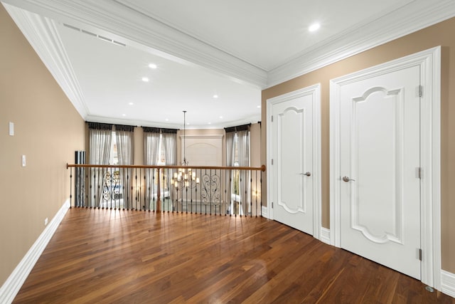 unfurnished room with baseboards, ornamental molding, wood finished floors, an inviting chandelier, and recessed lighting