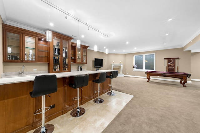 bar with light colored carpet, baseboards, indoor wet bar, decorative light fixtures, and crown molding