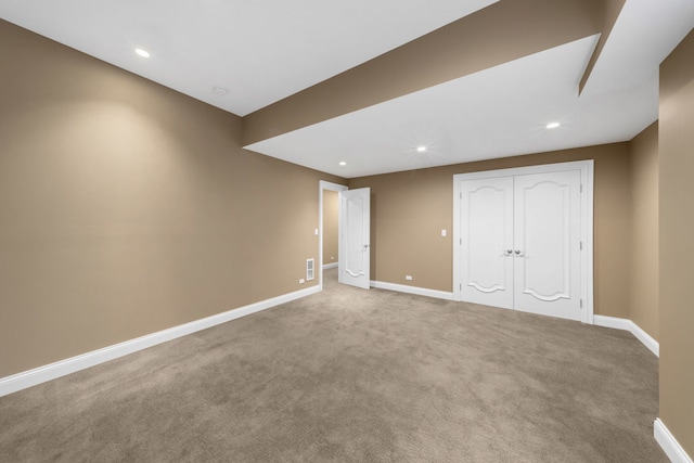 unfurnished bedroom featuring carpet floors, a closet, recessed lighting, and baseboards