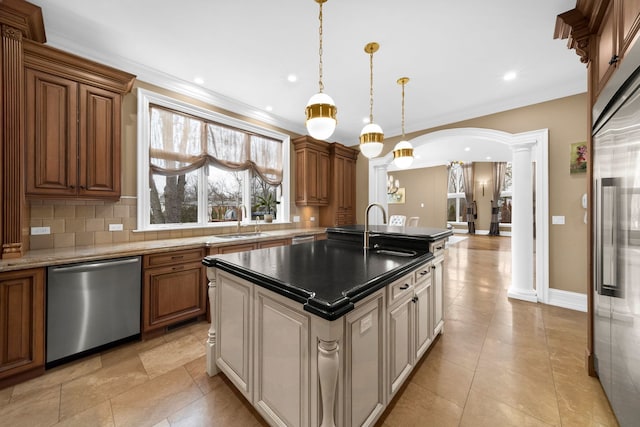 kitchen featuring arched walkways, a sink, dishwasher, tasteful backsplash, and ornate columns