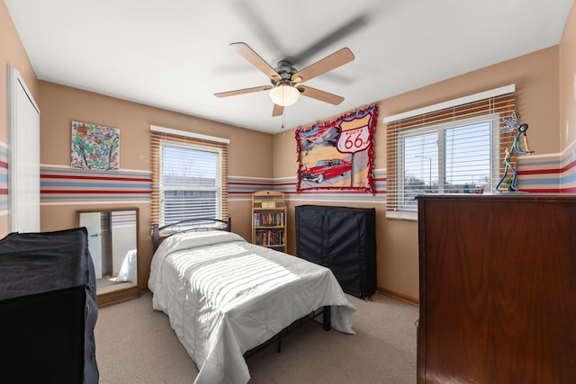 bedroom featuring light carpet and ceiling fan