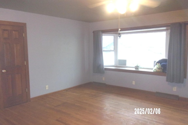 empty room with hardwood / wood-style flooring