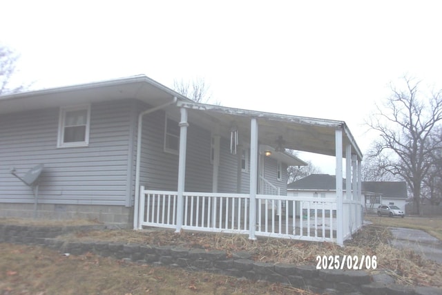 view of side of home with a porch