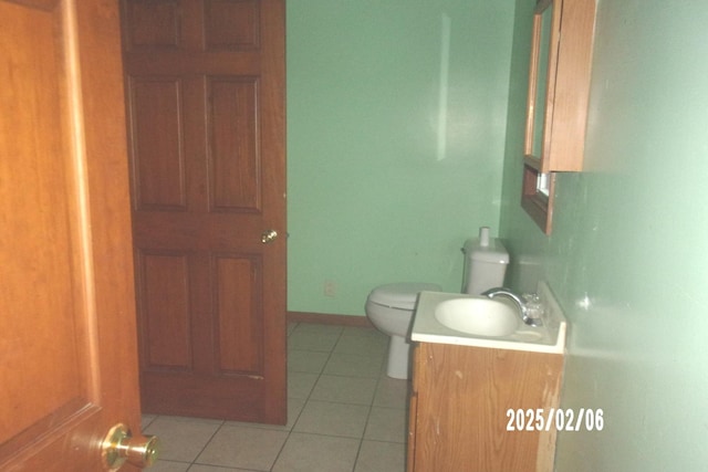 bathroom featuring tile patterned floors, toilet, and vanity