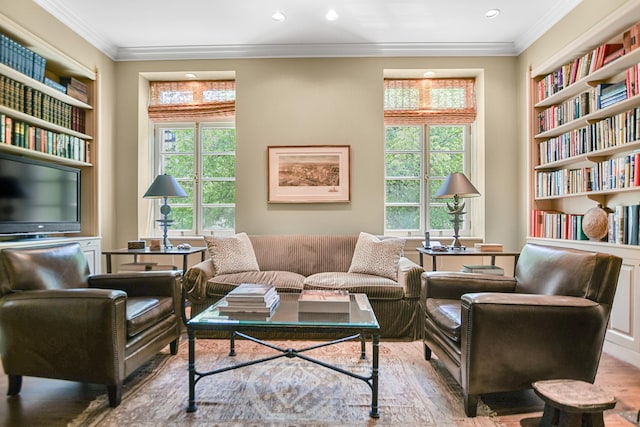 sitting room featuring crown molding, built in features, and light hardwood / wood-style flooring