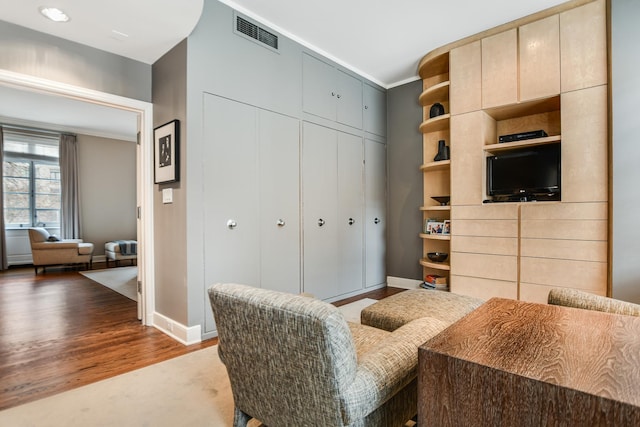 interior space featuring crown molding and dark hardwood / wood-style floors