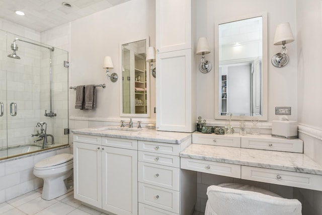 full bathroom featuring vanity, shower / bath combination with glass door, and toilet