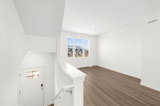 entryway with dark hardwood / wood-style flooring