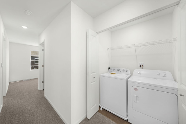 laundry room featuring dark carpet and washing machine and clothes dryer