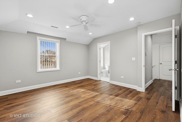 unfurnished bedroom featuring dark wood-type flooring, ceiling fan, lofted ceiling, and connected bathroom