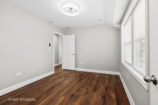 unfurnished bedroom featuring dark hardwood / wood-style floors and vaulted ceiling