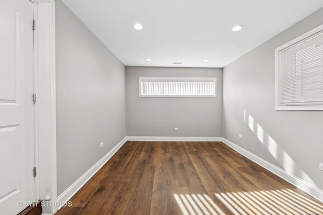 unfurnished room with dark wood-type flooring