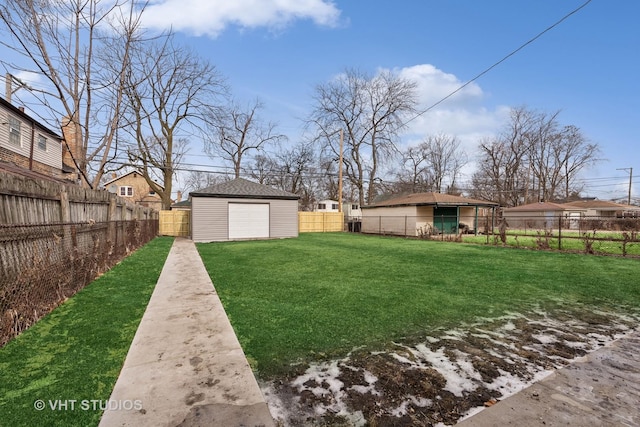 view of yard featuring a garage and an outdoor structure