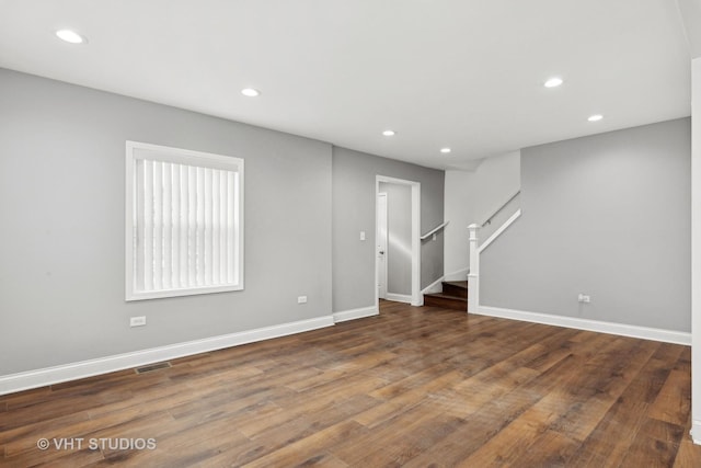 spare room featuring dark wood-type flooring