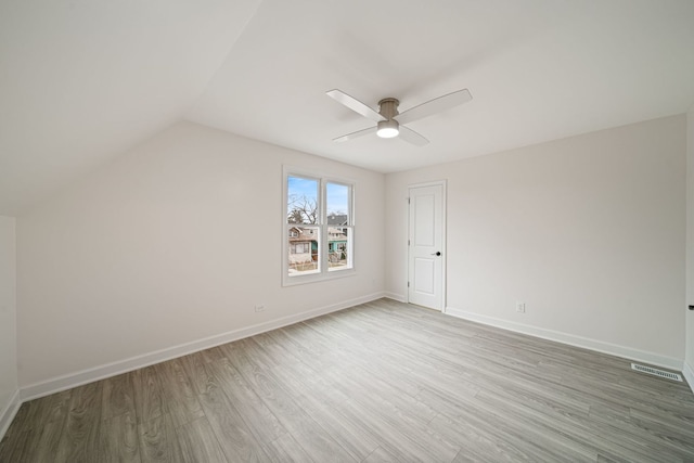 additional living space with lofted ceiling, hardwood / wood-style flooring, and ceiling fan