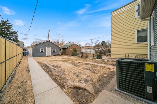 view of yard featuring cooling unit and an outdoor structure