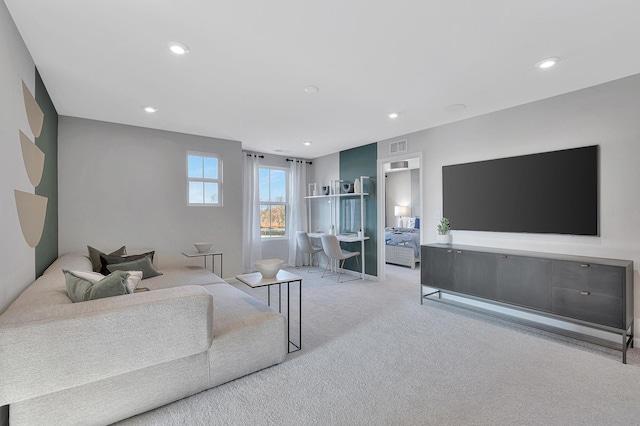 carpeted living area featuring visible vents and recessed lighting