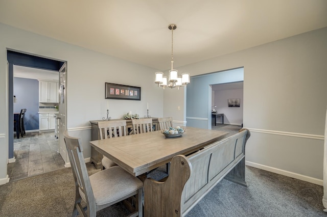 dining room with an inviting chandelier and light colored carpet