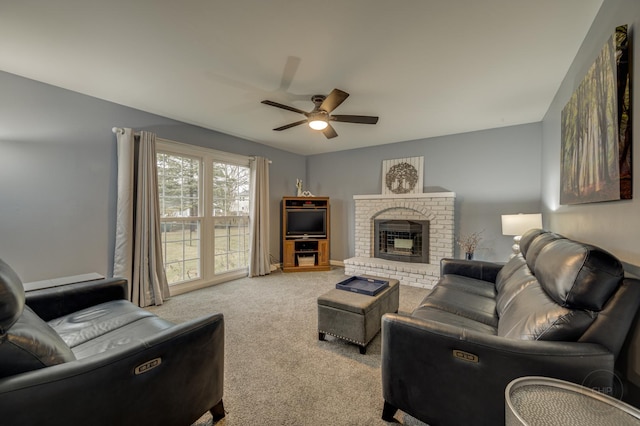 living room featuring a fireplace, light colored carpet, and ceiling fan