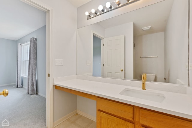 bathroom featuring vanity and toilet