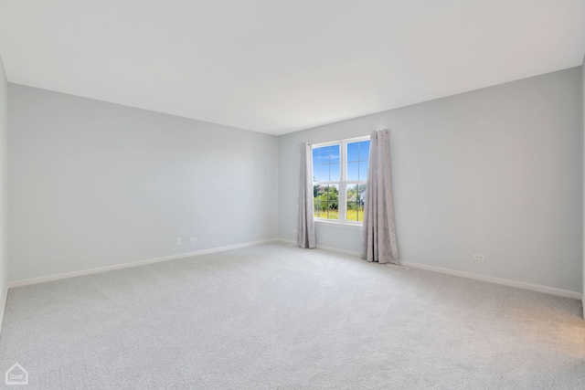 unfurnished room featuring light colored carpet