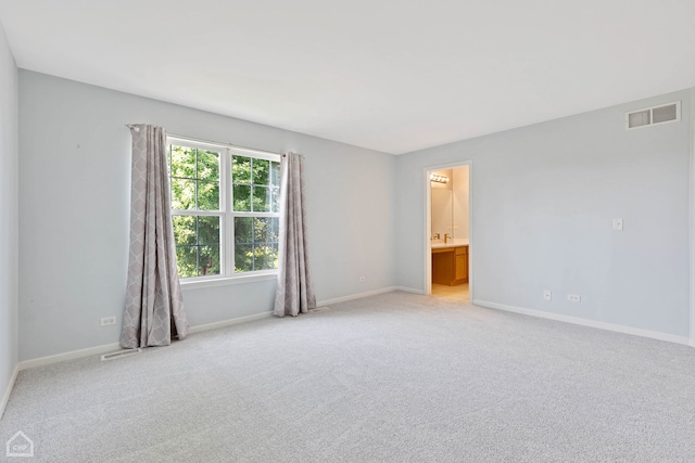 empty room with light carpet and sink