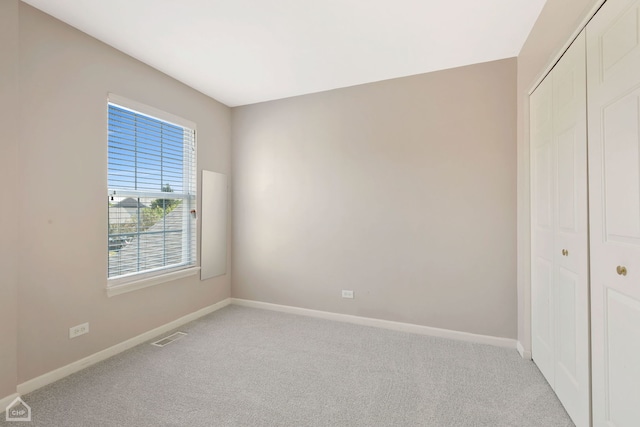 empty room featuring light carpet