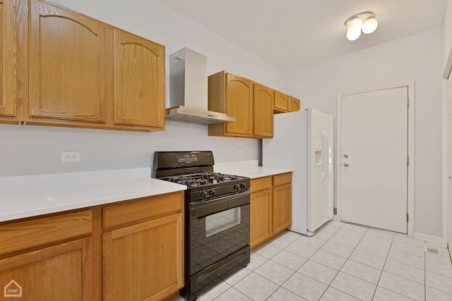 kitchen featuring wall chimney exhaust hood, white fridge with ice dispenser, light tile patterned floors, and black gas range oven