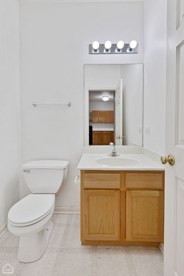 bathroom with vanity, tile patterned floors, and toilet