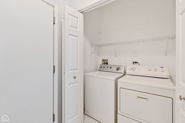 clothes washing area with washing machine and dryer