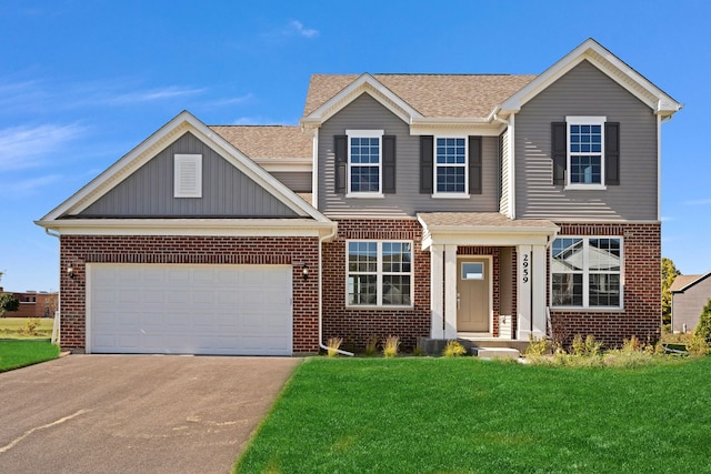 view of front of property with a garage and a front yard