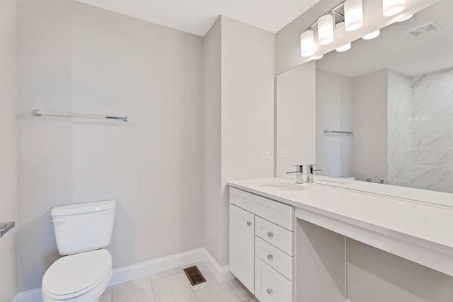 bathroom with vanity, toilet, and tile patterned flooring