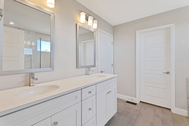 bathroom featuring walk in shower and vanity