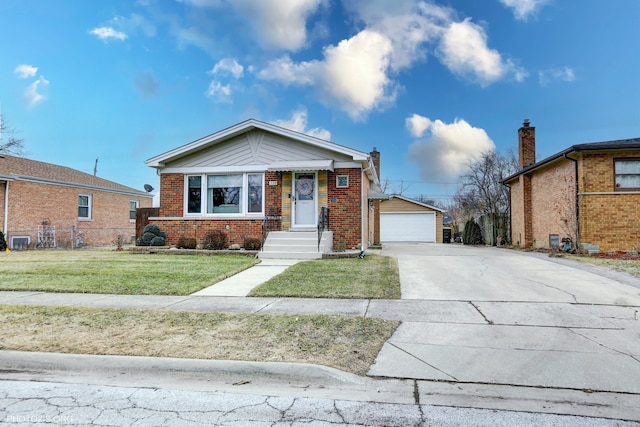 view of front facade featuring a garage, an outbuilding, and a front yard