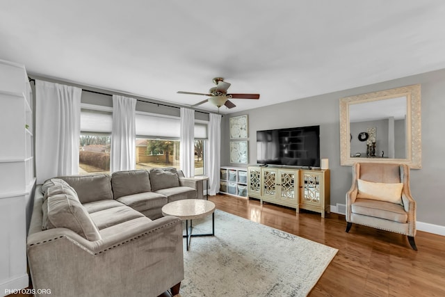 living room featuring hardwood / wood-style floors and ceiling fan