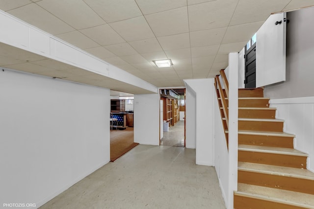 basement with a paneled ceiling