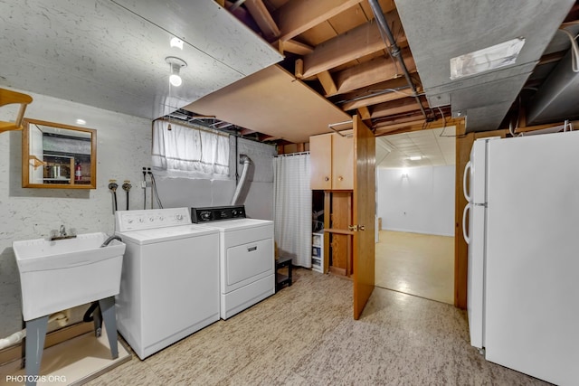 washroom featuring washing machine and clothes dryer and sink