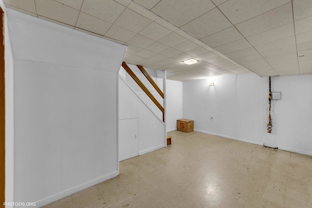 basement with a paneled ceiling