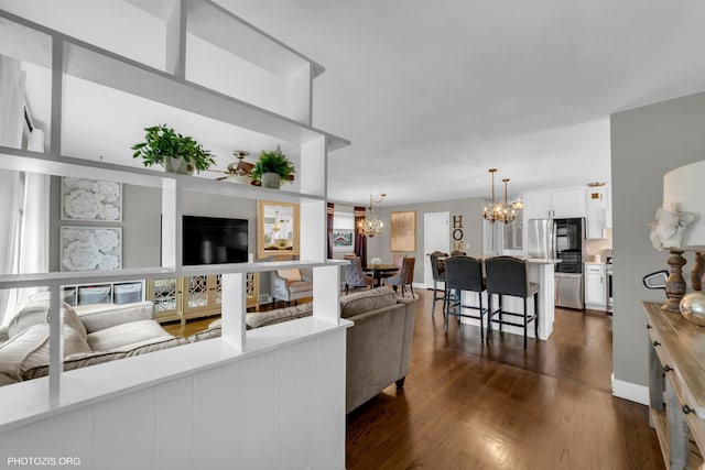 living room featuring dark hardwood / wood-style flooring and a chandelier