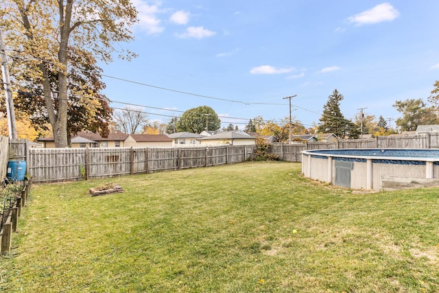 view of yard with a fenced in pool