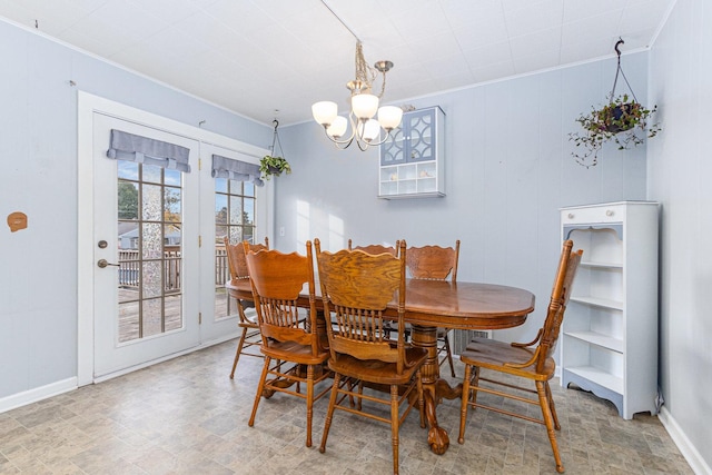 dining space featuring ornamental molding and a notable chandelier